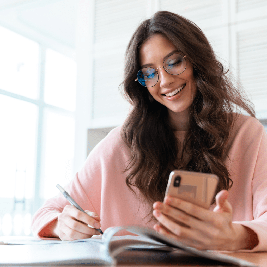 Happy woman writing moving notes