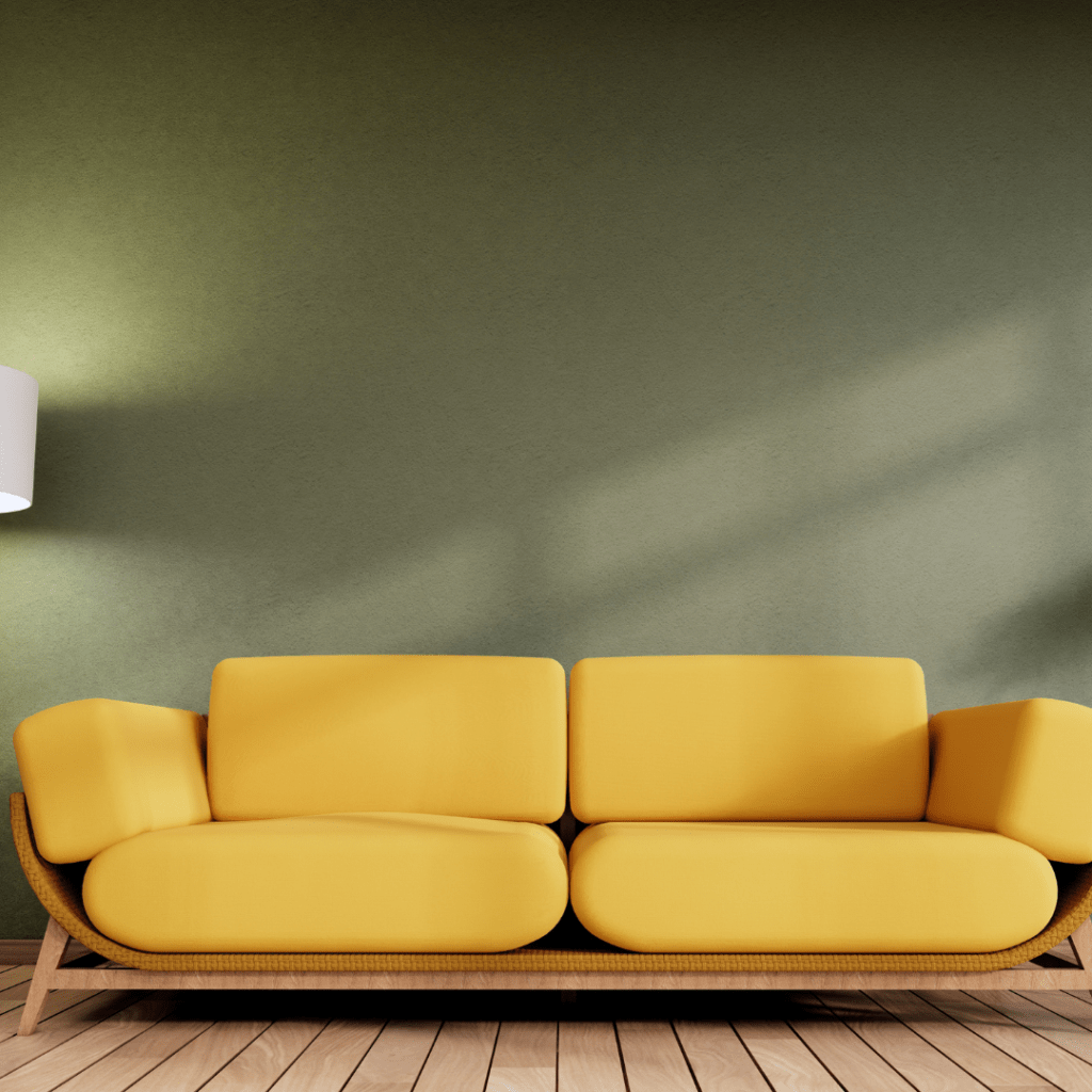 Yellow sofa beside a green wall